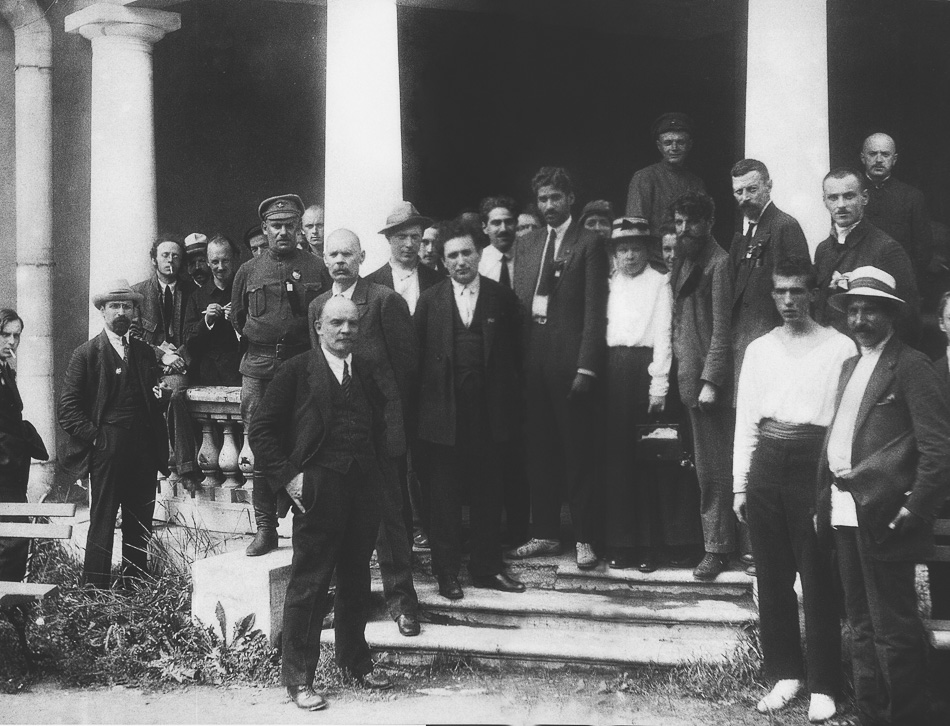 Caption: MN Roy (centre, black tie and jacket) with Vladimir Lenin (tenth from the left), Maxim Gorky (behind Lenin), and other delegates to the Second Congress of the Communist International at the Uritsky Palace in Petrograd. 1920. Credit: Magazine Krasnay Panorama (Red Panorama) / Wikipedia.