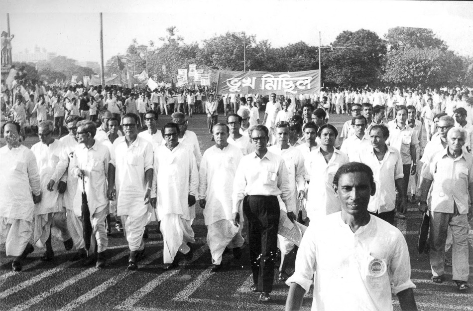 Caption: Communist leader Jyoti Basu (sixth from the left in the front row; no glasses), who later became the Chief Minister of West Bengal, at a Bhukha Michhil (’procession of the hungry’), during the Food Movement of 1959. Credit: Ganashakti